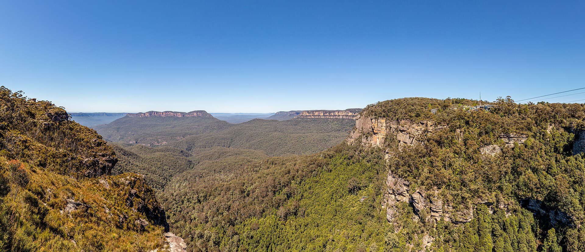 Layered sandstone escarpments of the Blue Mountains receding into blue haze